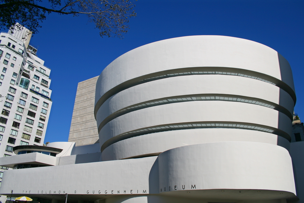 The Solomon R. Guggenheim Museum’s white spiral facade stands out against a clear blue sky in New York City.