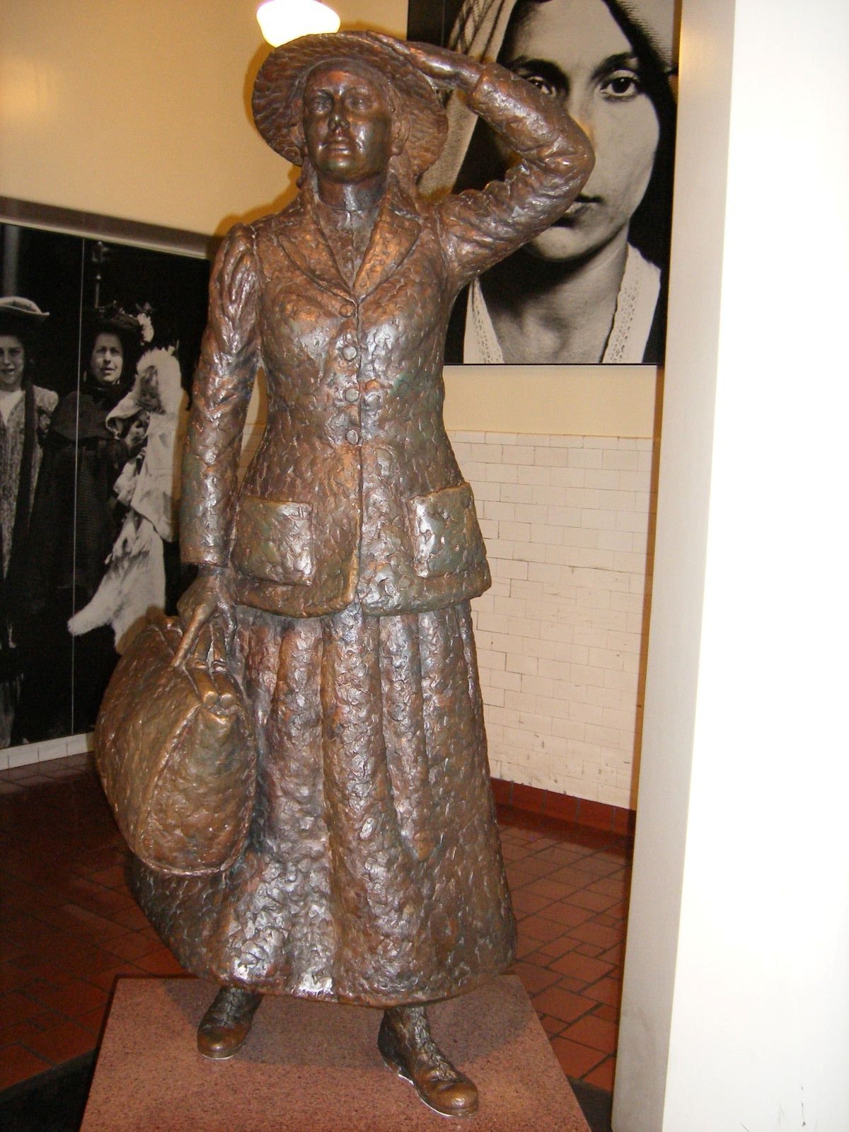 A bronze statue at Ellis Island of the first immigrant, Annie Moore. 