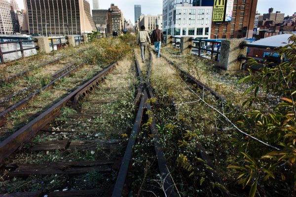 People walking the old train tracks at the High Line park in New York.