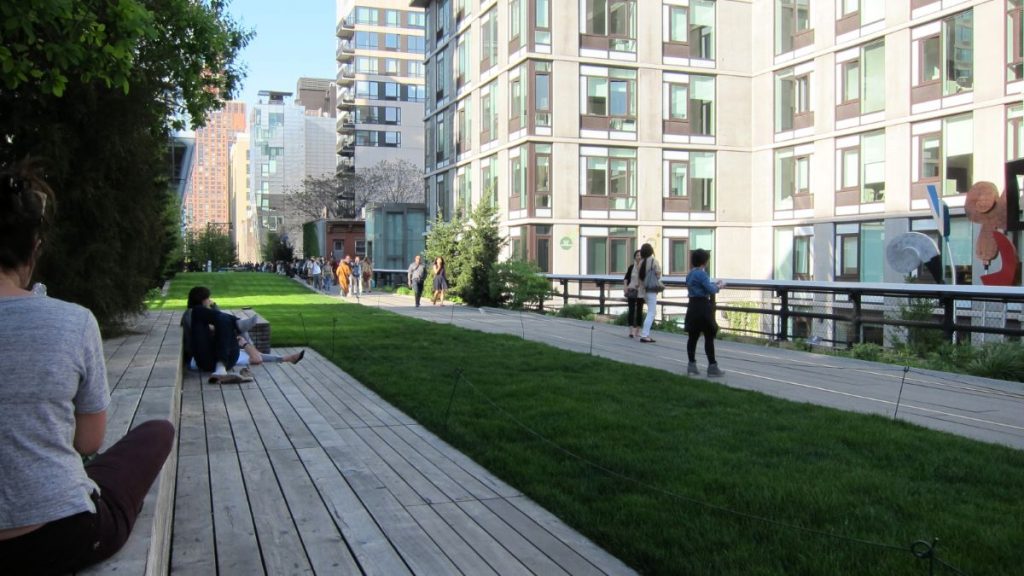 People relaxing on benches at New York City park. 