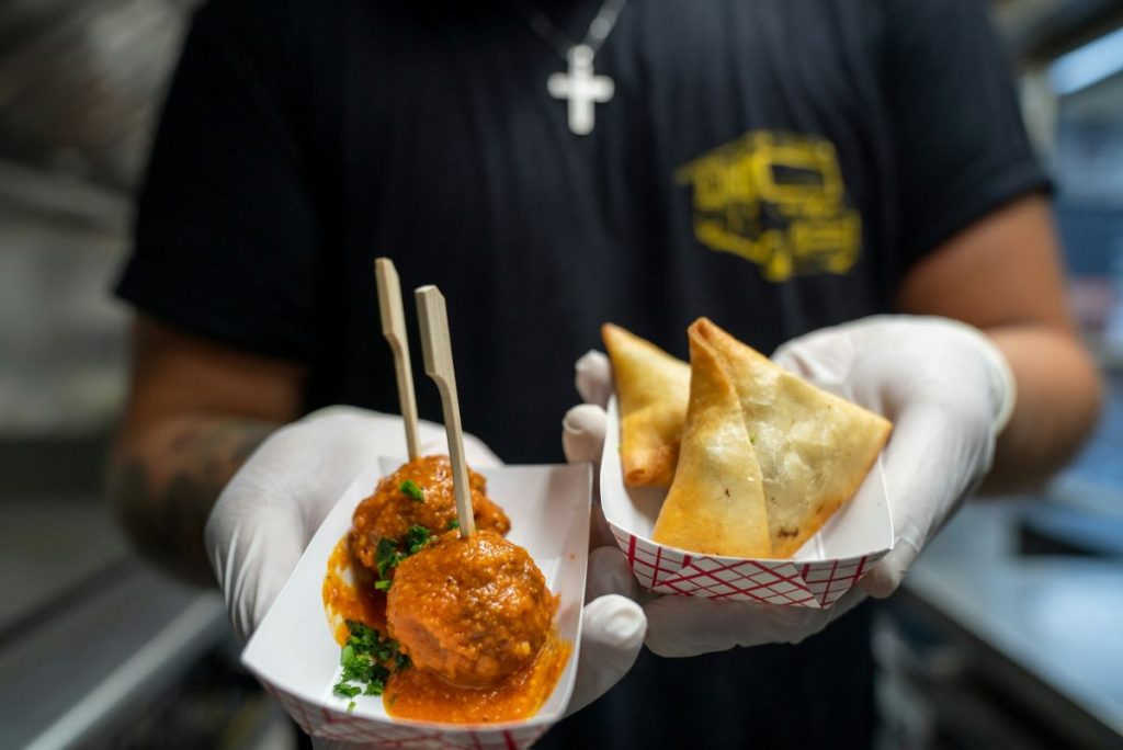 A chef holding Lebanese street food. 