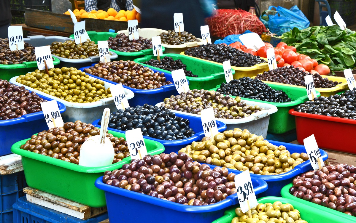 Outdoor market in Athens, Greece with tubs of black and green olives