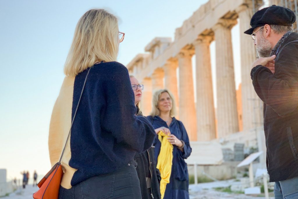 Guide explains the Parthenon to visitors in Athens, Greece