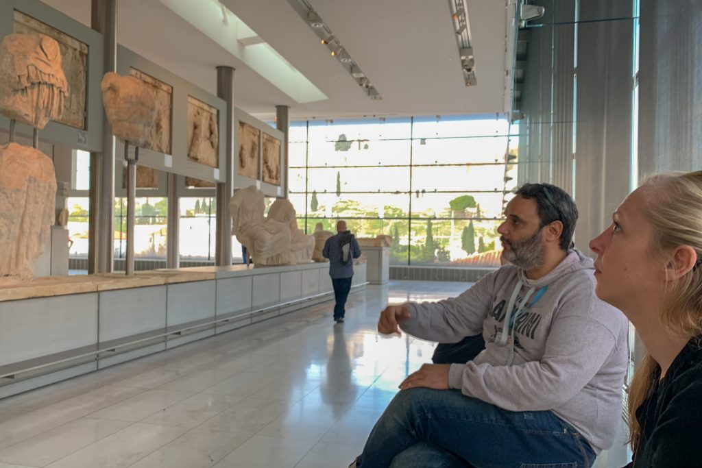 Guide explaining friezes to guests at the New Acropolis Museum