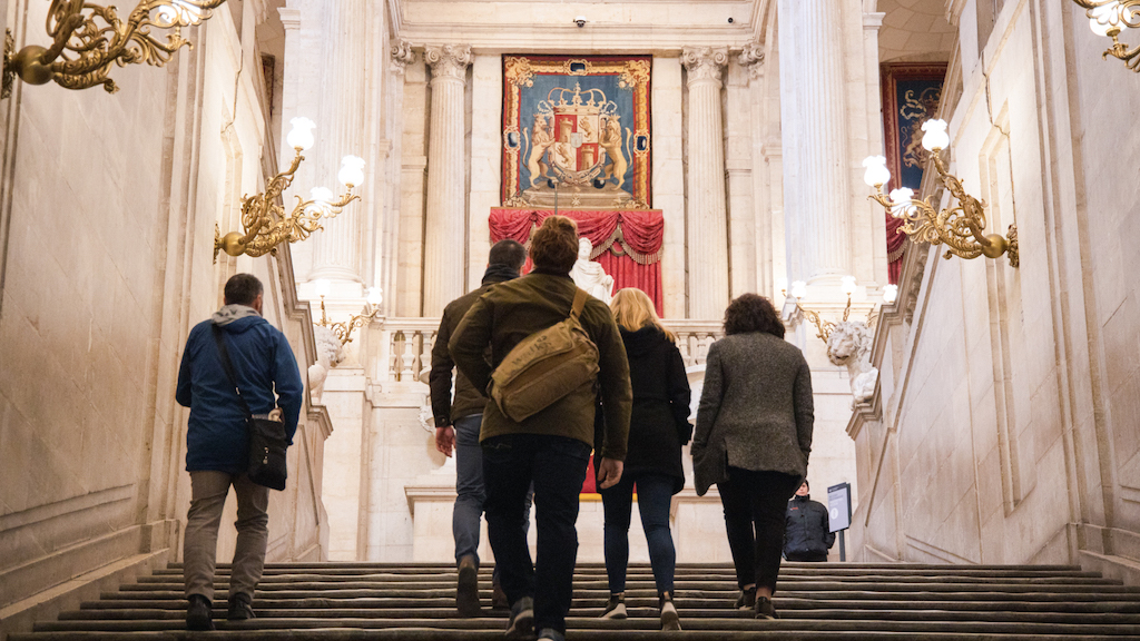 Small group of visitors entering Madrid's Royal Palce