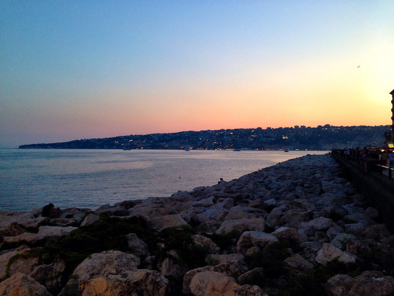 Sunset over the water in Naples, Italy