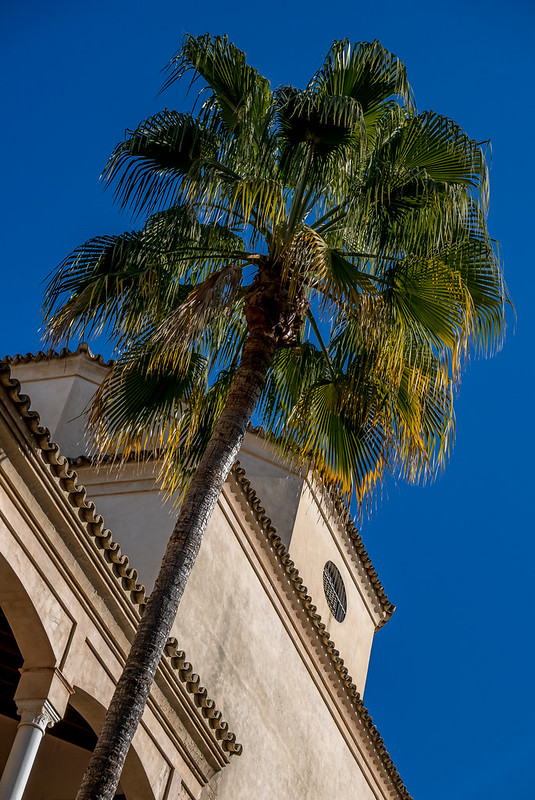 A partial view of the Palacio Marqueses de la Algaba on a perfectly sunny day in Seville.