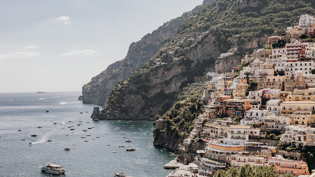 Amalfi Coast photo of Positano with mountains, buildings, and boats