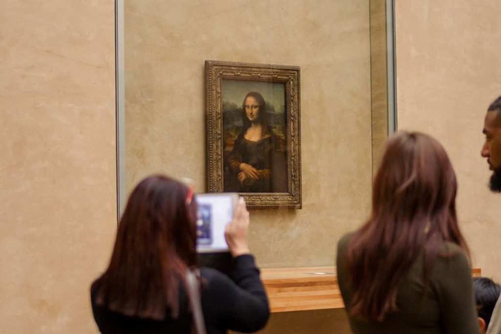 People taking pictures of the Mona Lisa
