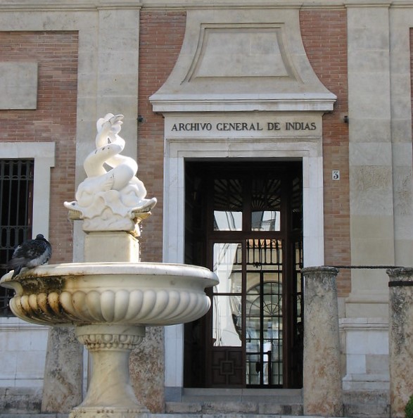 A bird has a bath in the fountain outside of the Archivo General de Indias building in center city, Sevilla.