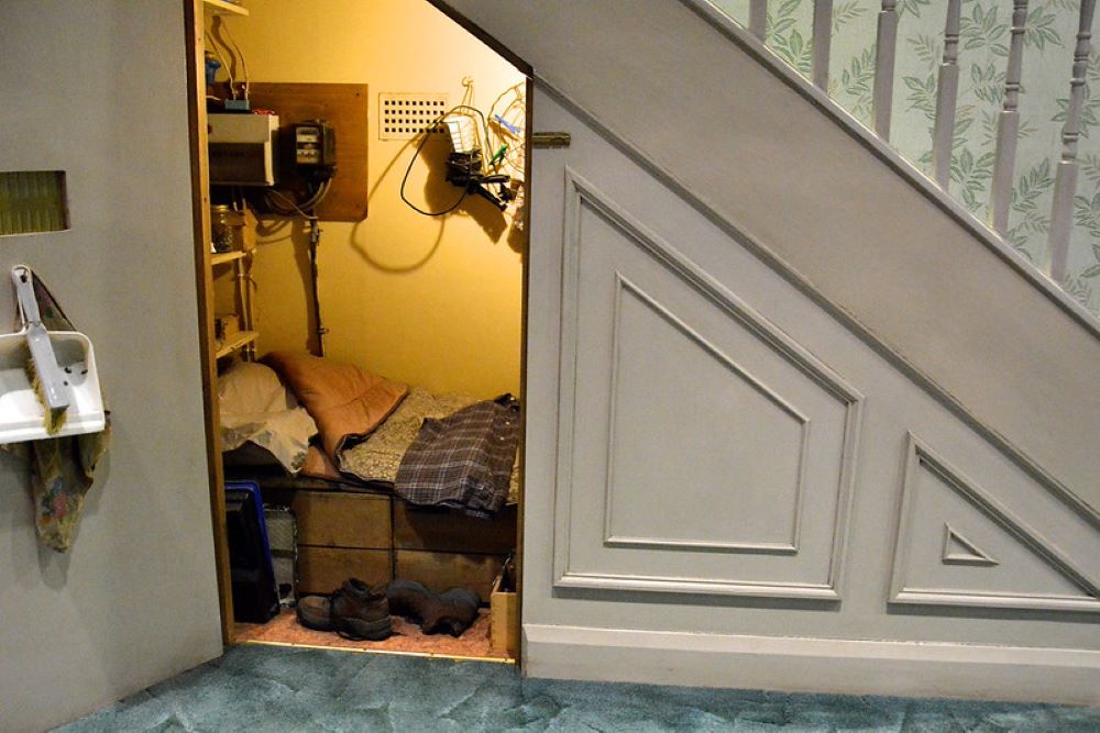 A view inside the set of Harry Potter, displaying his bedroom in the cupboard under the stairs