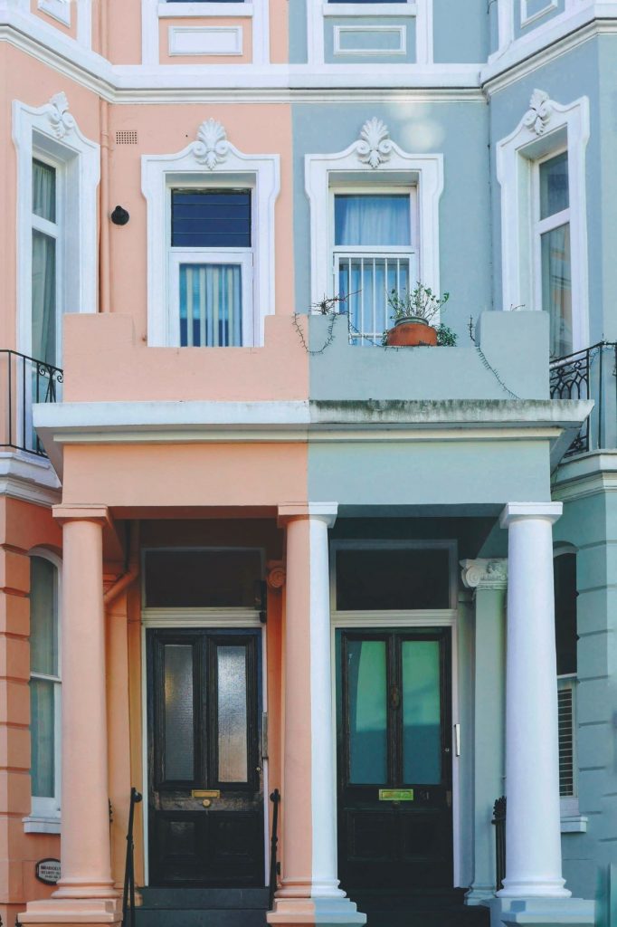 A pink and blue apartment building in Notthing Hill, London