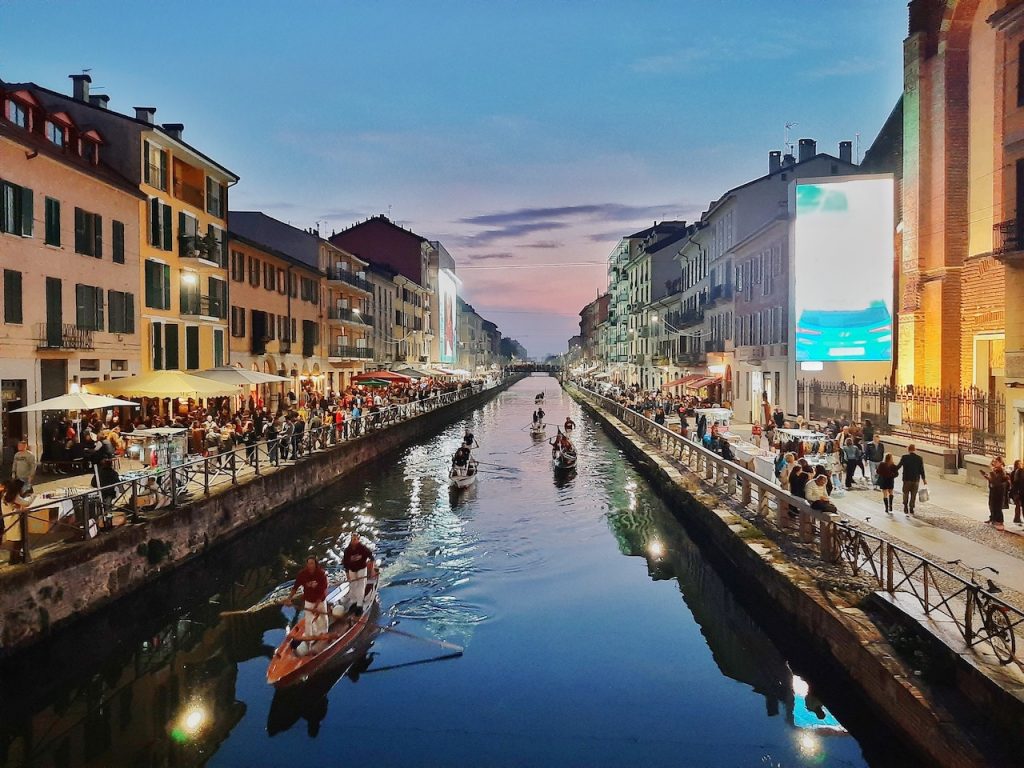 Navigli district of Milan with canal, streetside restaurants, boats, and more, at night