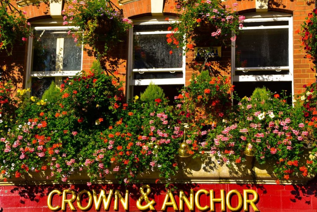 The Crown & Anchor pub in London, with flowers hanging near the sign