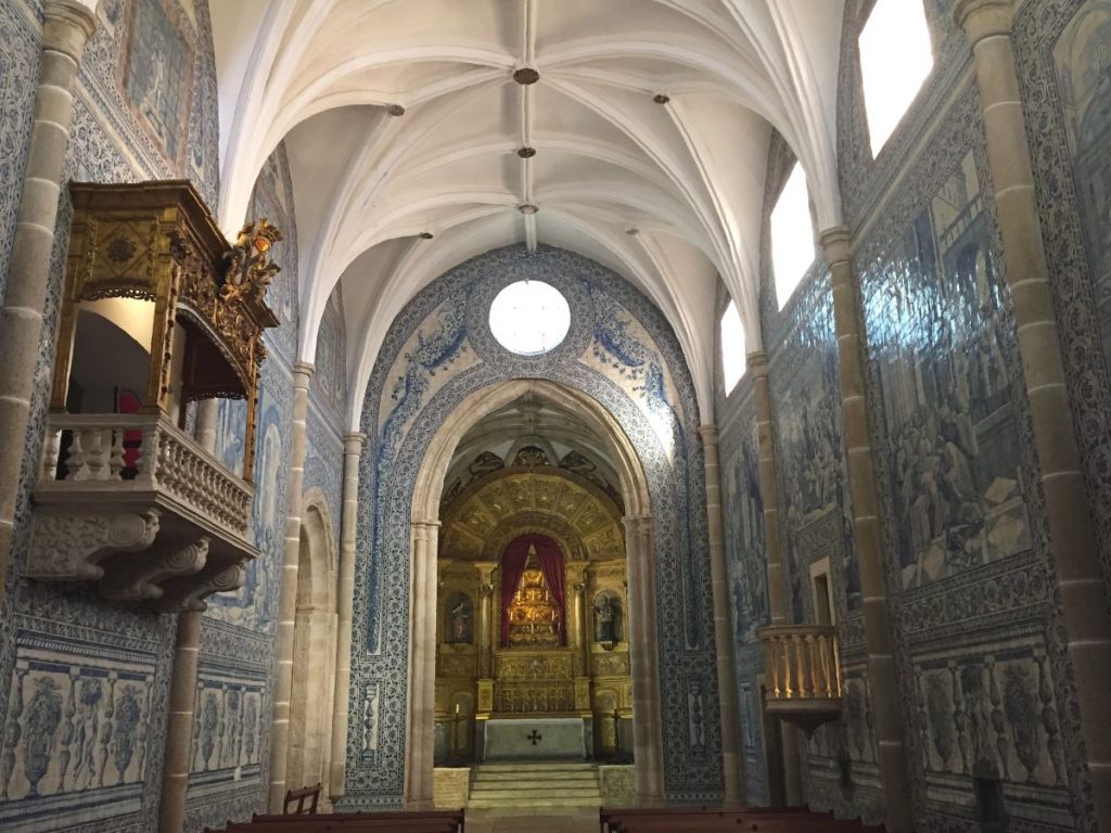 inside a church with beautiful white and blue tiled walls