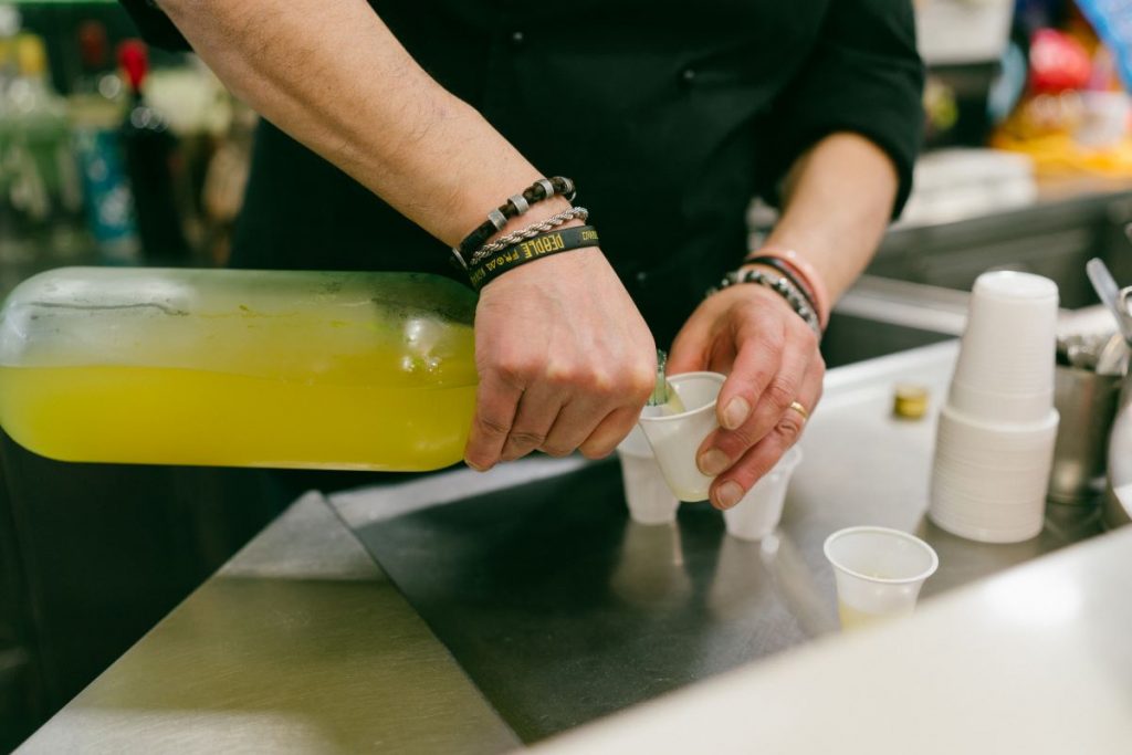 limoncello being poured into small cups