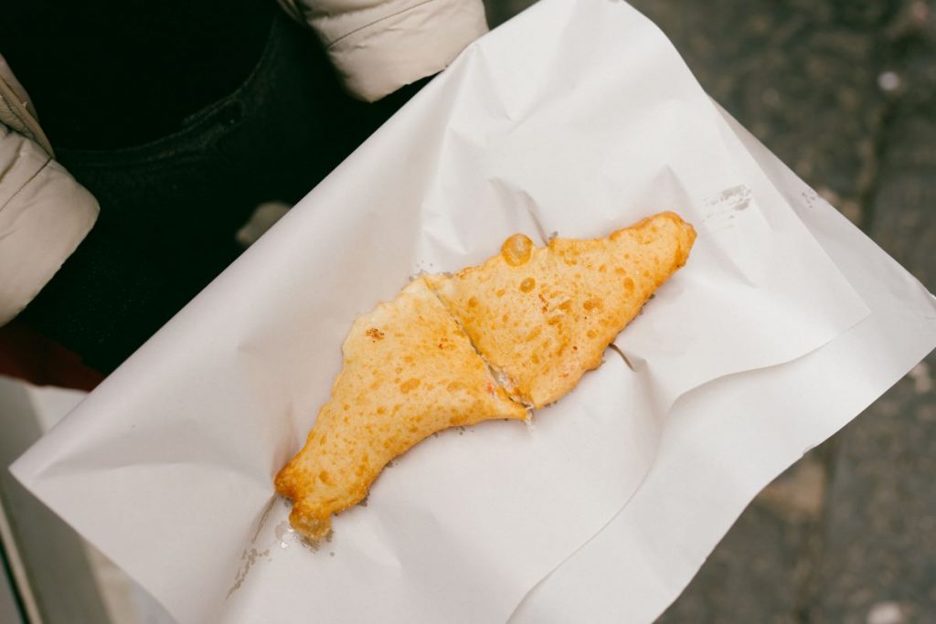 fried pizza sitting on a napkin