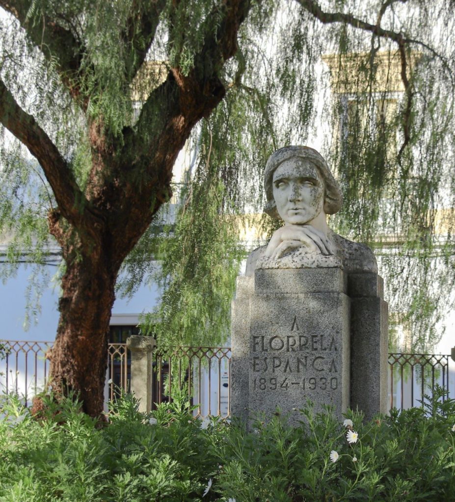 bust of poet in garden surrounded by flowers and trees