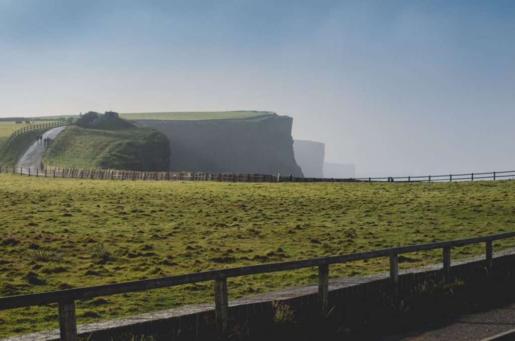 a road with cliffs in the background