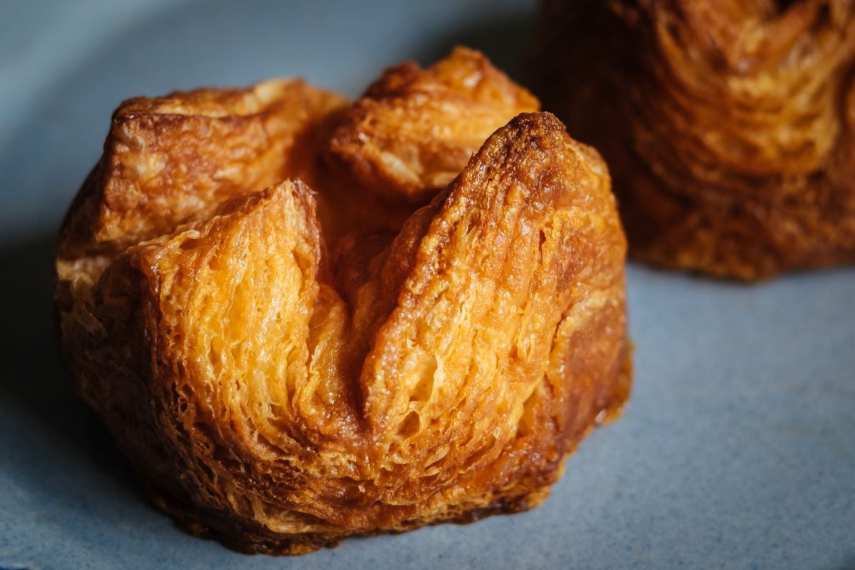 Closeup of a caramelized multi-layered pastry. Also known as a kouign-amann.