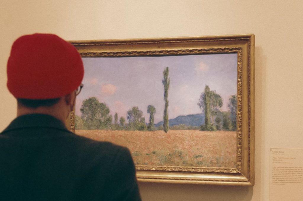 man looking at a painting