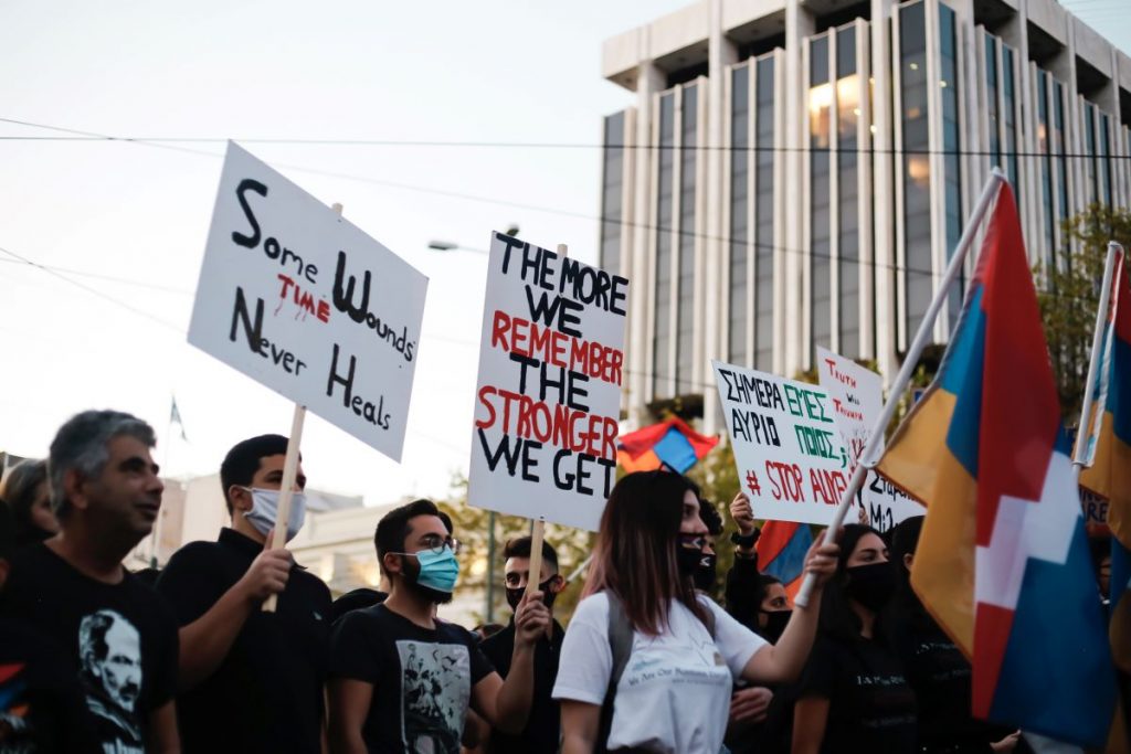 protesters in the street holding signs