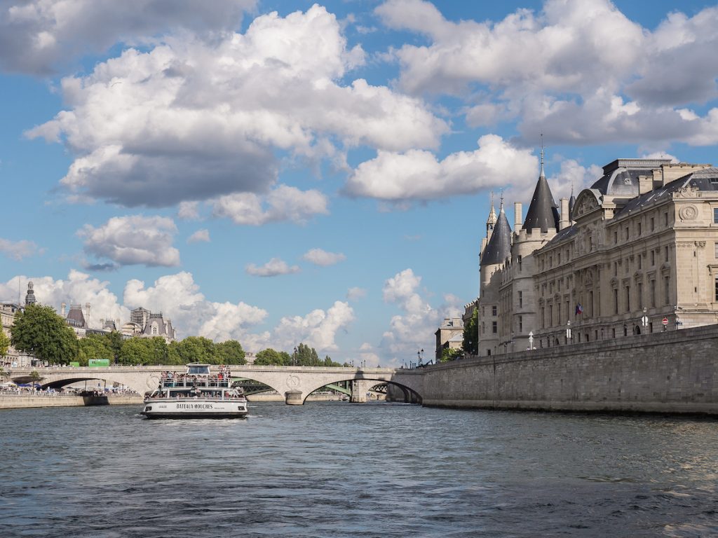 La Conciergerie, a boat and the river Seine in Paris