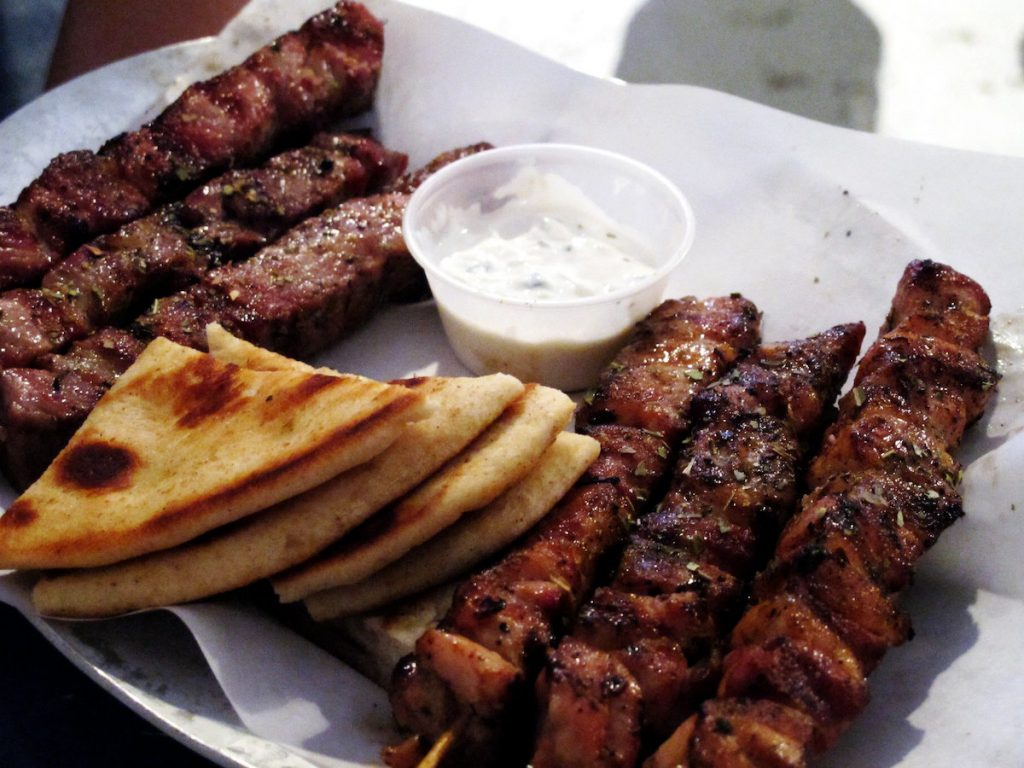 meat on a plate with pita and sauce
