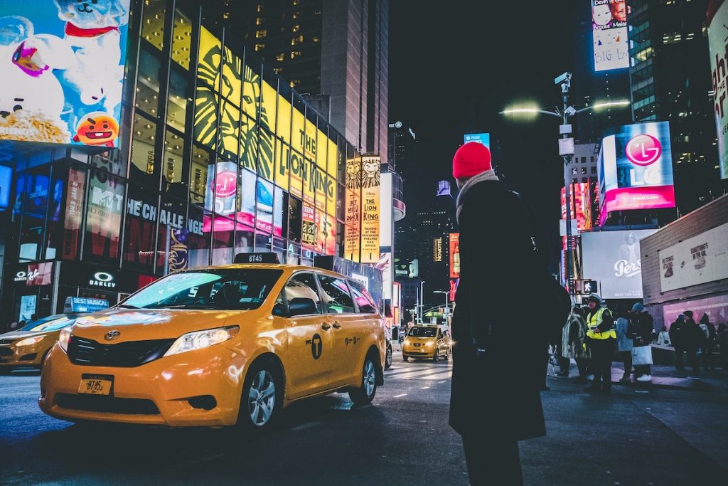 Person and NYC taxi during night