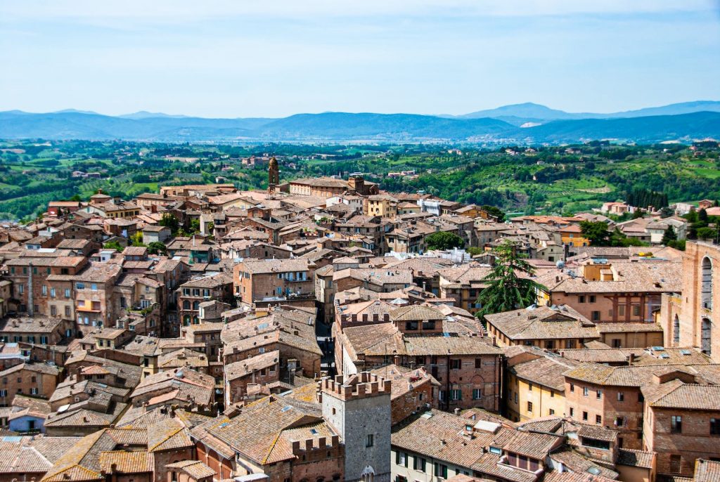 View of the Tuscan Town of Siena and surroundings near Florence rooftops blue sky