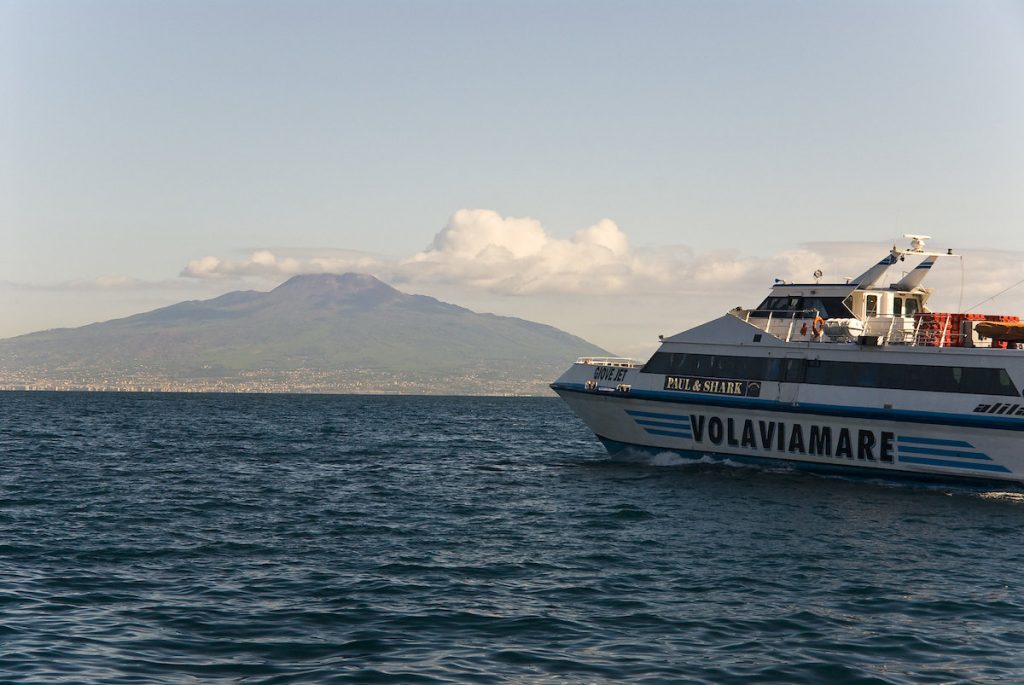 a boat on the water with mountains in the background