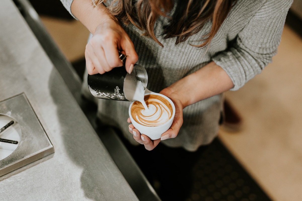 Person pouring a cup of coffee