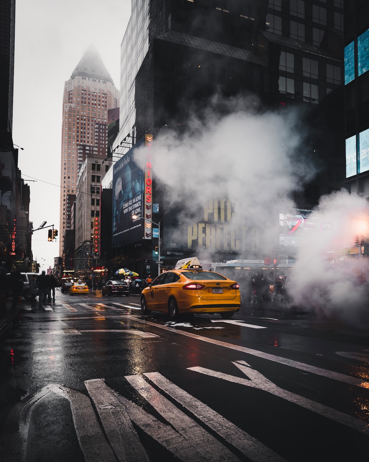Steam venting in Manhattan with a taxi