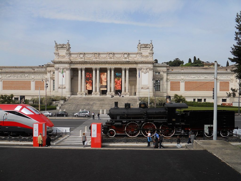 people walking in front of a museum entrance