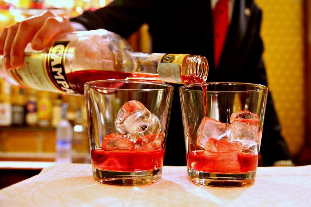 campari being poured into drinks