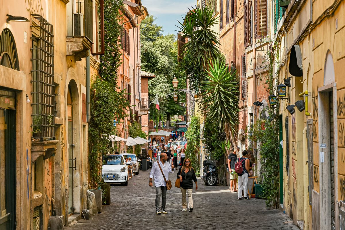 people walking down the street in Rome