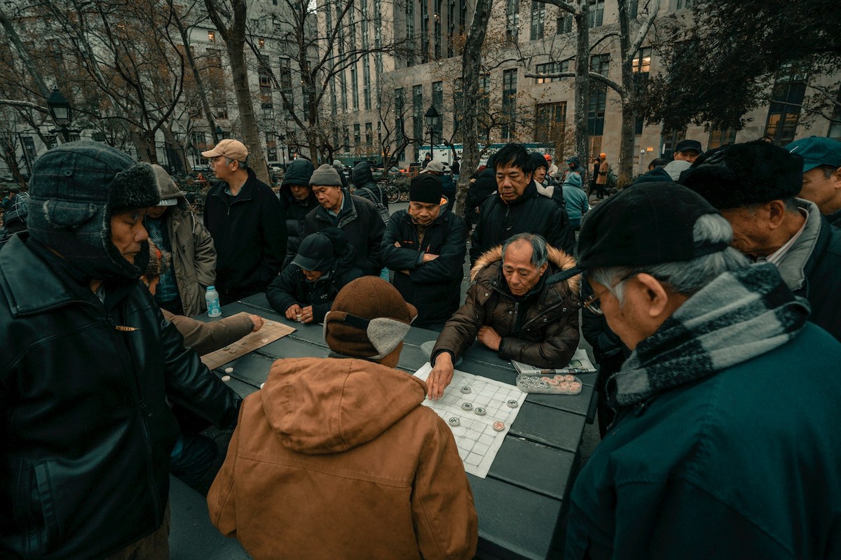 Men playing Chinese chess in Columbus Park, Chinatown NYC