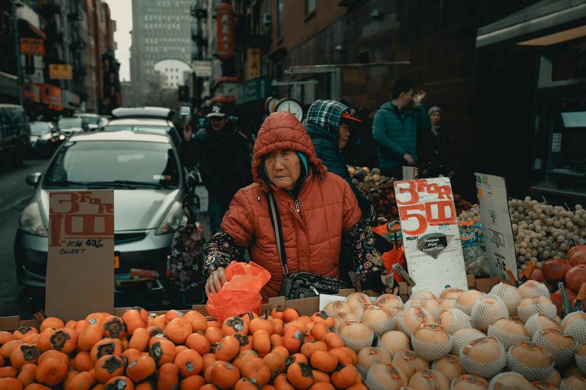 Woman selling fruits in Chinatown NYC