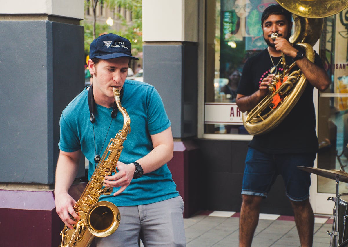 two men playing jazz in the street