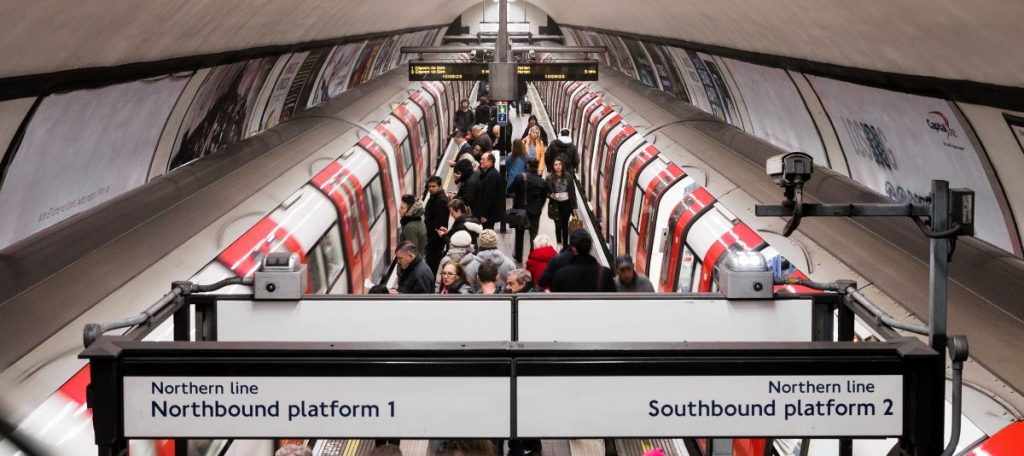 A busy platform where people are using the London underground. 