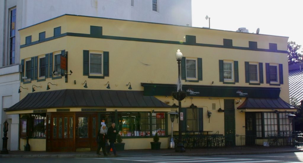 people crossing the street in front of a restaurant