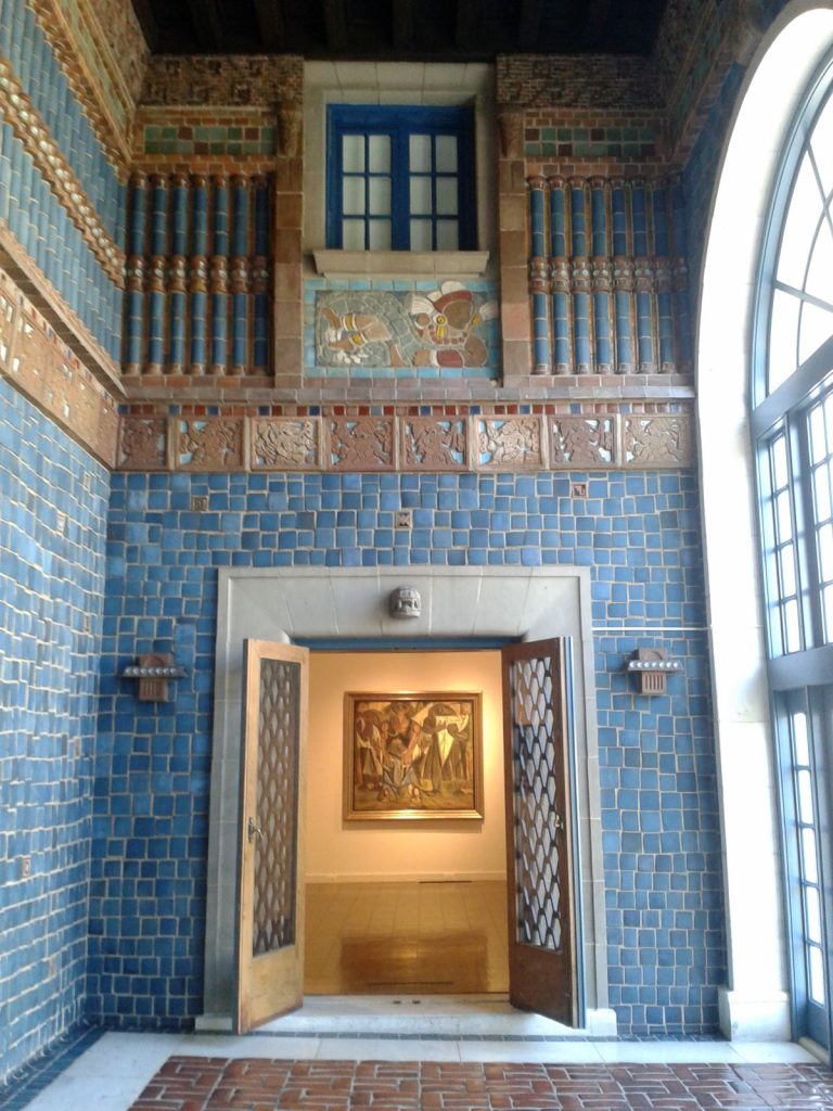 ornate interior space with blue tiled walls