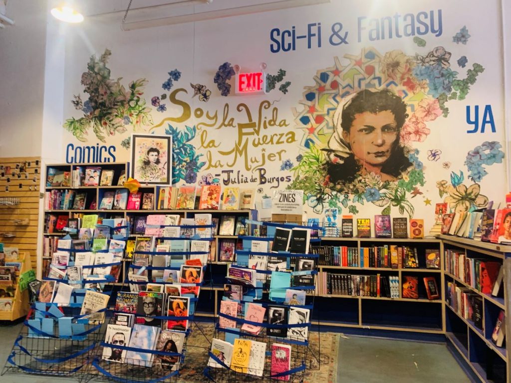 interior space of bookstore with mural of woman's face on the wall