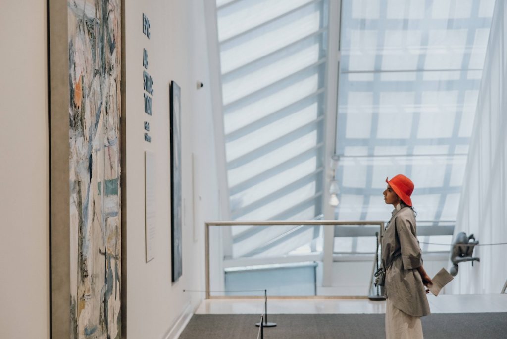 woman looking at painting inside the met