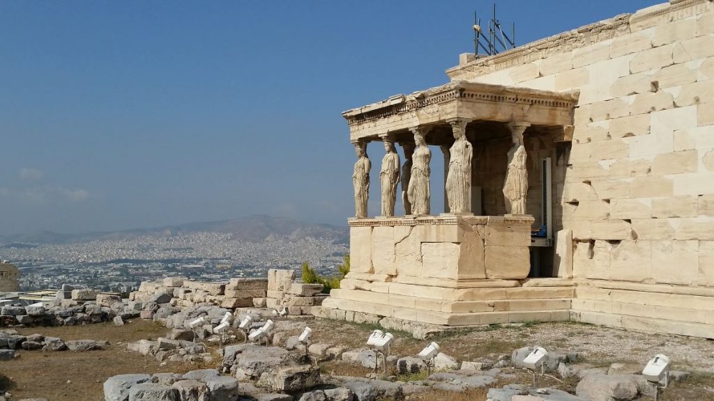 large building with columns made out of statues.