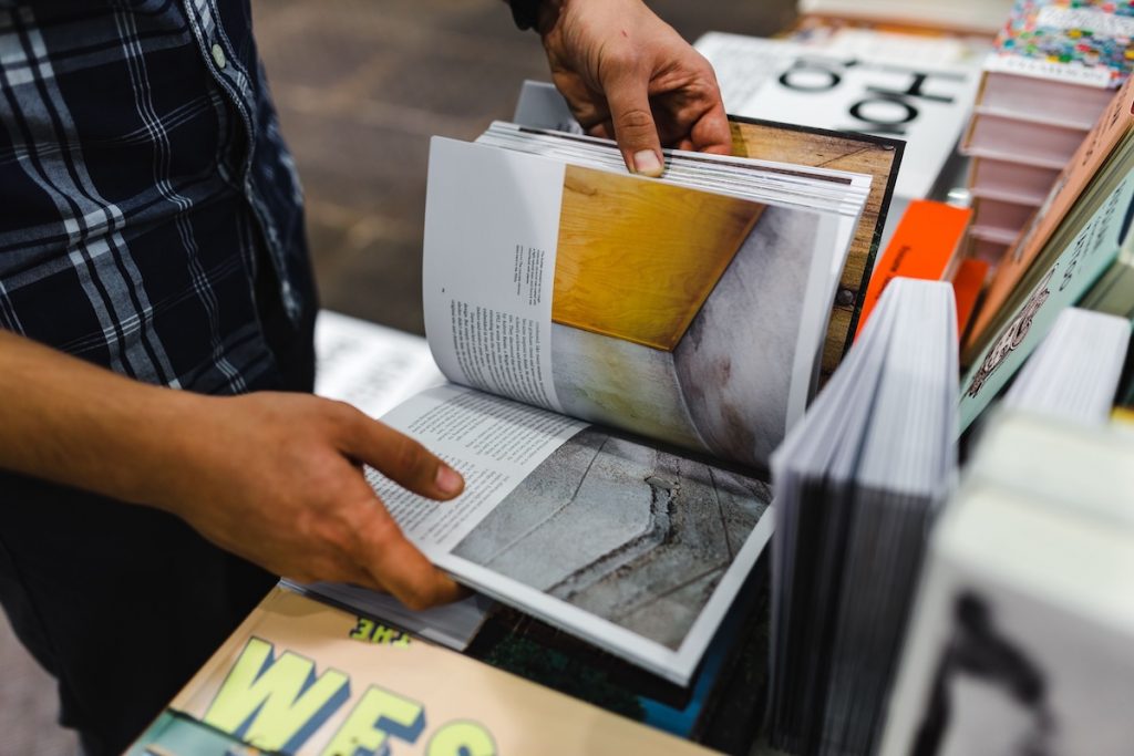 man looking through a book