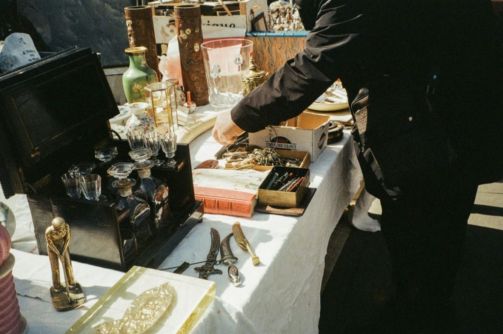 Woman looking around at antiques at an antique market.