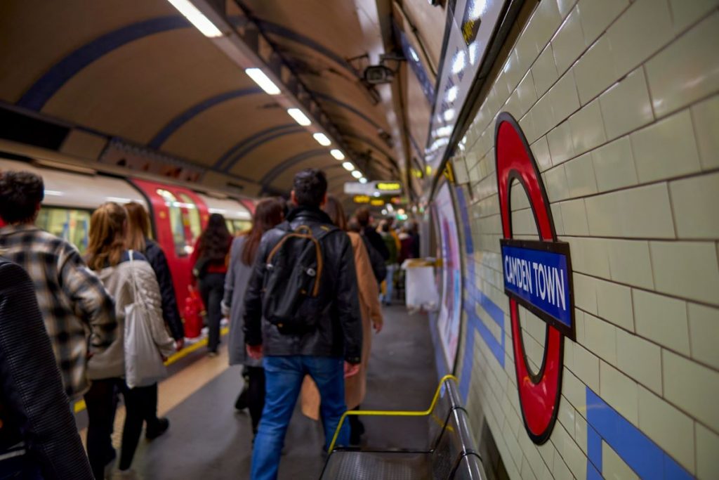 People using the London underground exiting the train in London. 