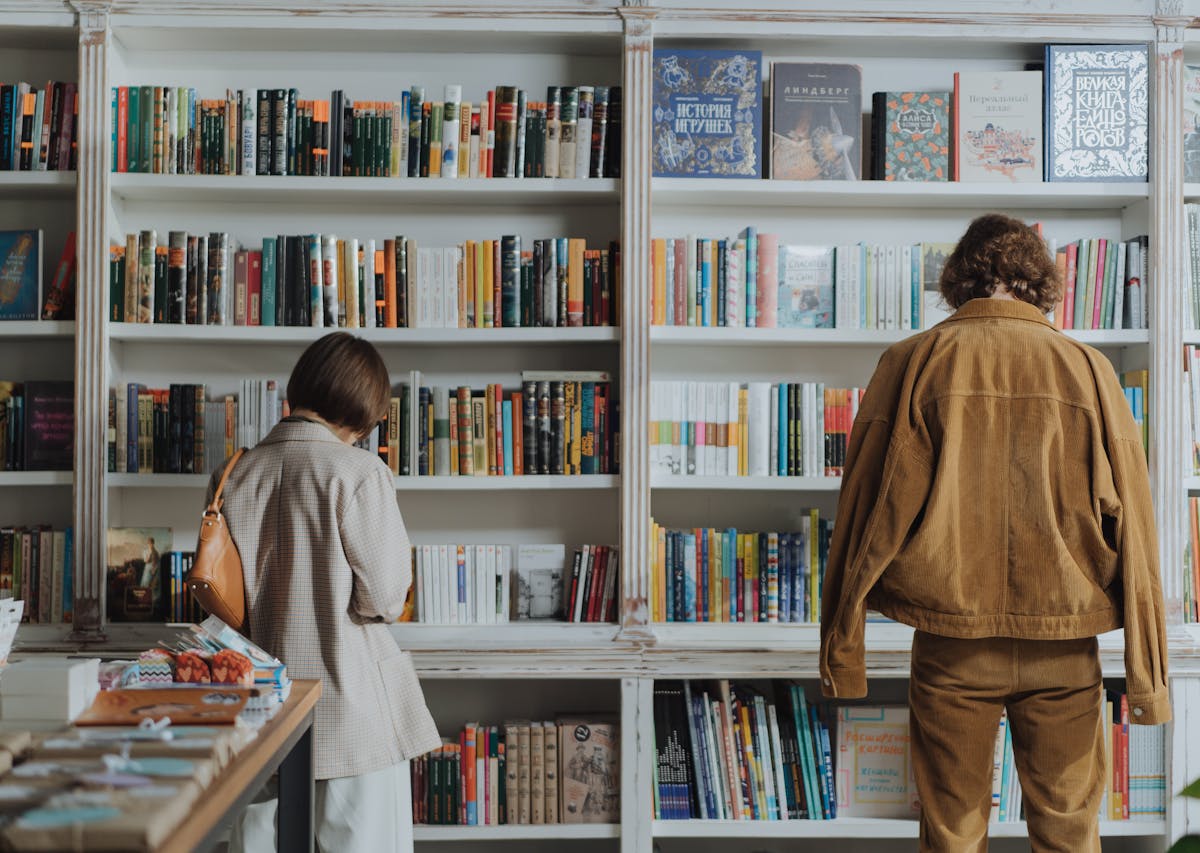 People looking at a bookshelf