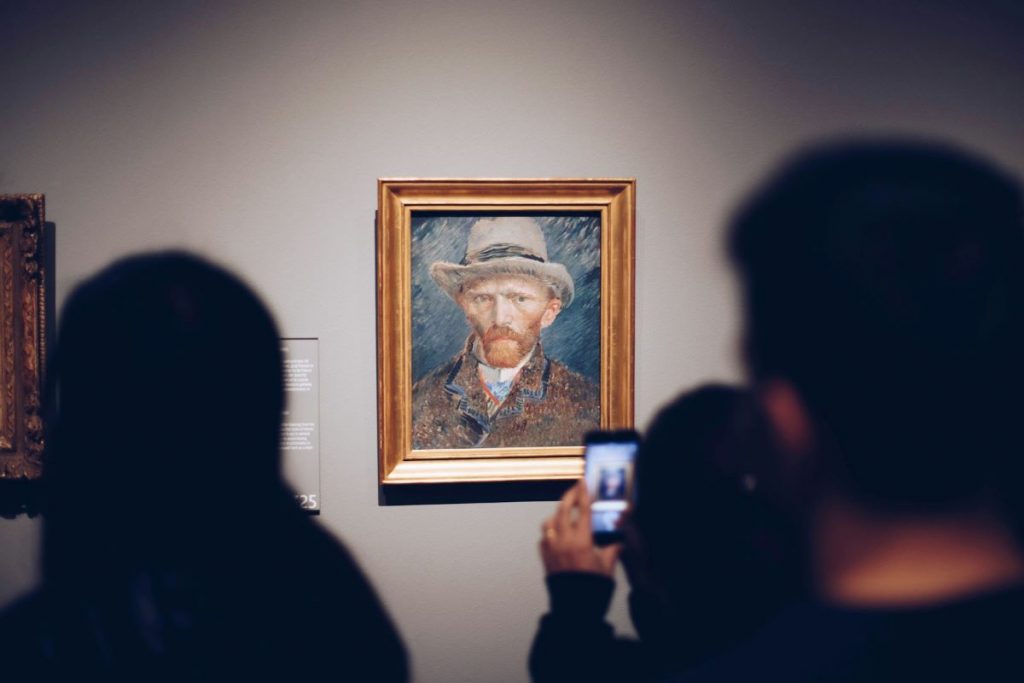 People at the Van Gogh museum looking at a painting.